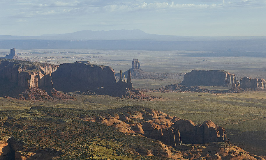 Distant aerial view of Three Sisters in morning haze. Monument Valley, Arizona, USA. - Monument-Valley-Agathla-Peak-El-Capitan-Owl-Church-Rock - Mike Reyfman Photography