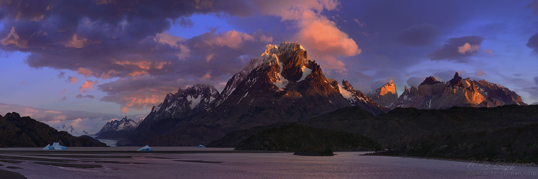 Windy sunrise over Cordillera del Paine. Panoramic view of Lago Grey, Cerro Paine Grande and Cuernos del Paine. Torres del Paine National Park, Patagonia, Chile.