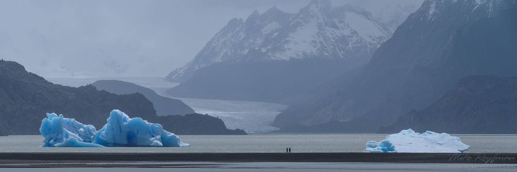 Tourists exploring icebergs in Lago Grey with Grey Glacier on the background. Torres del Paine National Park, Ultima Esperanza Province, Magallanes and Antartica Chilena Region XII, Patagonia, Chile.