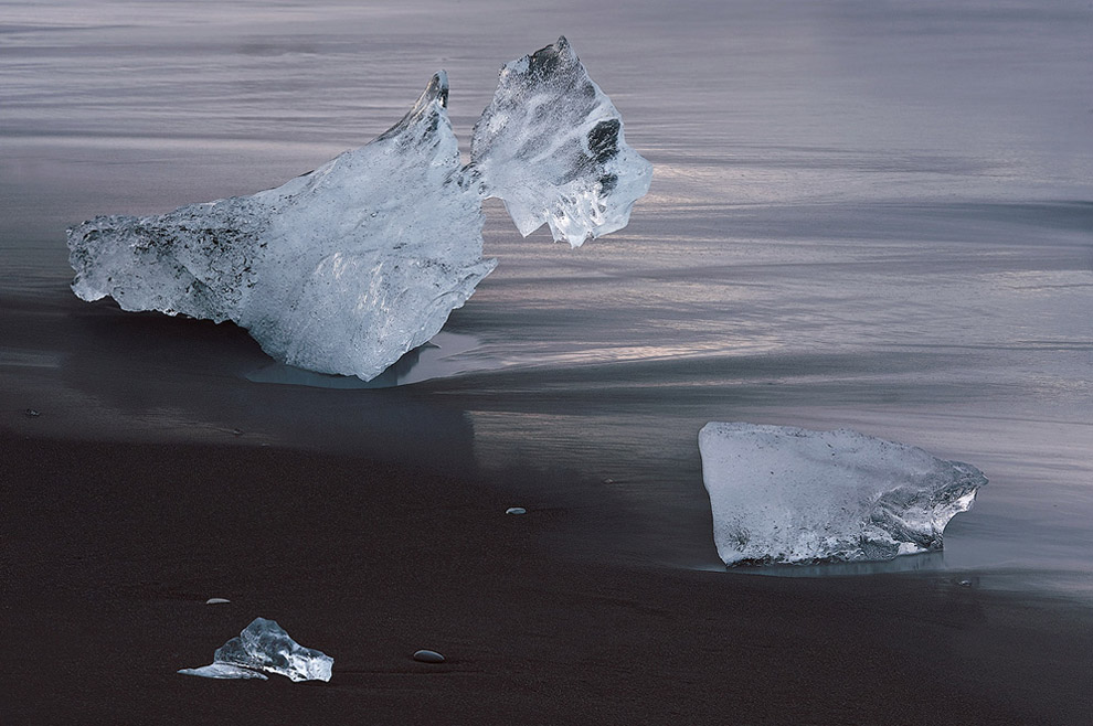 Awaiting of Inevitable. Iceberg on the Ocean coast near Jokulsarlon Glacial Lagoon, Iceland.