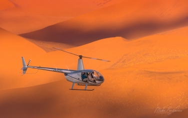 081-SV_10P8638 On Photo-Mission. Helicopter Flying Over Vast Expanse of Sand Dunes of Sossusvlei. Namib-Naukluft National Park, Namibia. Aerial.