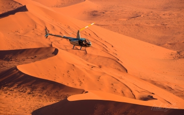 082-SV_10P8724 On Photo-Mission. Helicopter Flying Over Vast Expanse of Sand Dunes of Sossusvlei. Namib-Naukluft National Park, Namibia. Aerial.