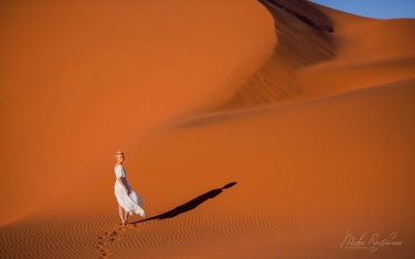098-SV_10N3635 Model on Orange Sand Dune. Sossusvlei, Namib Naukluft National Park, Namibia.