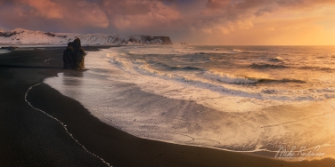 019-IC-CL_D8E3355-72_Pano-1x2 Arnardrangur (Eagle rock) basalt sea stack on the Kirkjufjara black volcanic sand beach with Mt. Reynisfjal and Reynisdrangar basalt sea stacks in the background. Cape Dyrholaey, Southern Iceland.