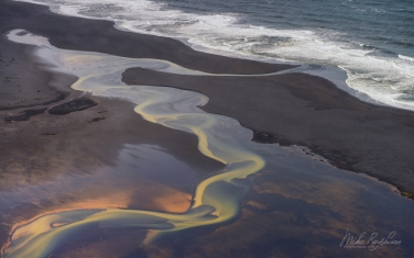 IC-CL AR-1 _D8B6886 Aerial view of multicolored glacial river floating into the Atlantic Ocean. Eastern Iceland.