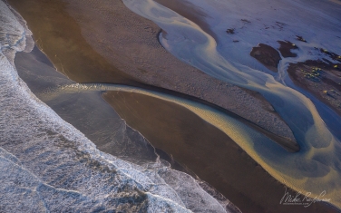 IC-CL AR-2 _D8B6444 Aerial view of multicolored glacial river floating into the Atlantic Ocean. Eastern Iceland.