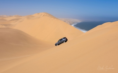 SCW_018_10P9139 Ship of the Desert. SUV in the sand dunes. Namib Skeleton Coast National Park, Namibia
