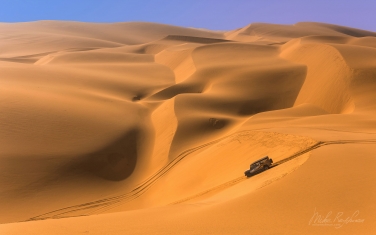 SCW_090_10N419 Ship of the Desert. Land Rover Defender in the sand dunes. Namib Skeleton Coast National Park, Namibia