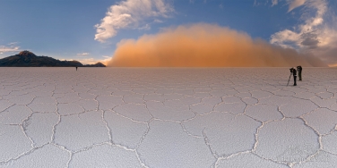 P12-MRAIR2405-16-Pano The Salt Storm. Salar de Uyuni near Tunupa Volcano. Altiplano, Bolivia.A low-lying cloud of airborne salt was painted in orange by low sun.