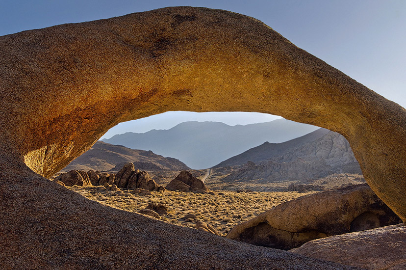 Looking through Mobius Arch to the Owens Valley and Inyo Mountains. Alabama Hills near Lone Pine. Eastern Sierra, California, USA. - Alabama-Hills-Eastern-Sierra - Mike Reyfman Photography