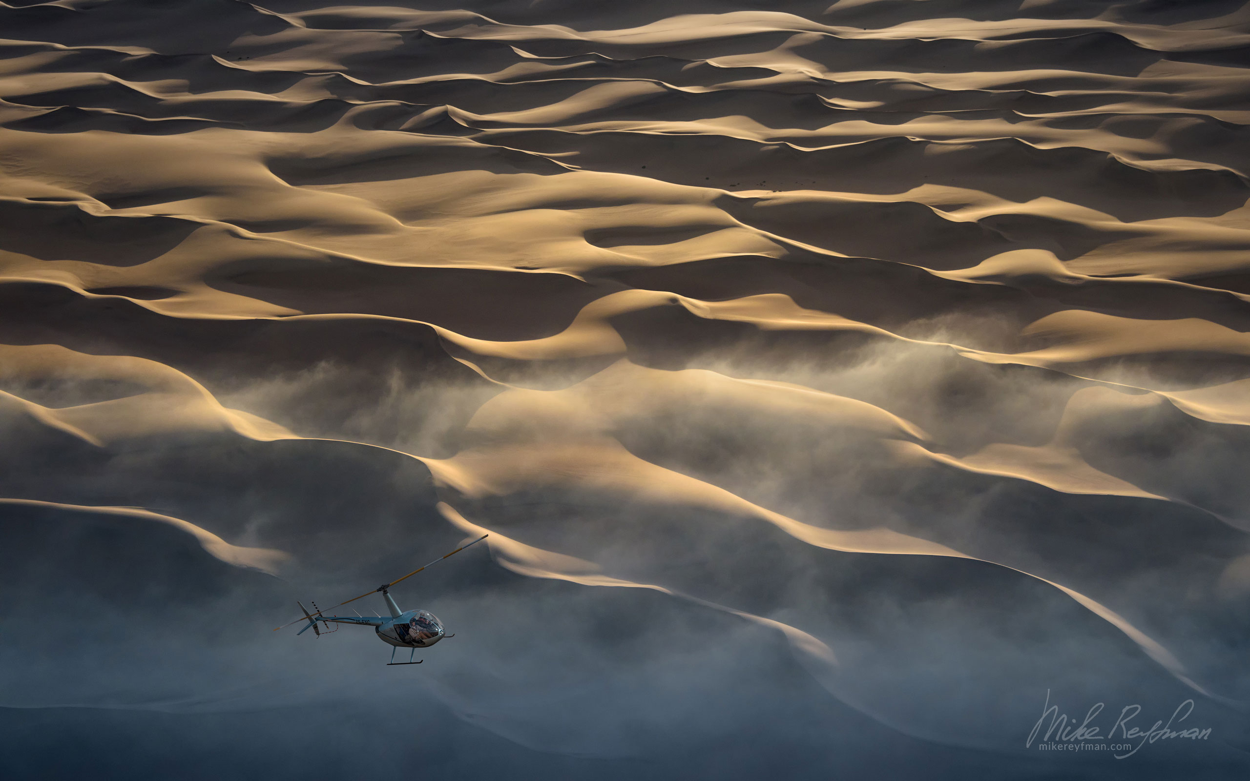 Helicopter in the fog over sand dunes of the Skeleton Coast. Namib Skeleton Coast National Park, Namibia SCW_007_10P8364 - Shipwrecks and Endless Dunes of Namib Skeleton Coast NP, Dense ocean fogs of the Benguela Current, Cape Fur seals, and Walvis Bay Salt Works. Namibia.  - Mike Reyfman Photography